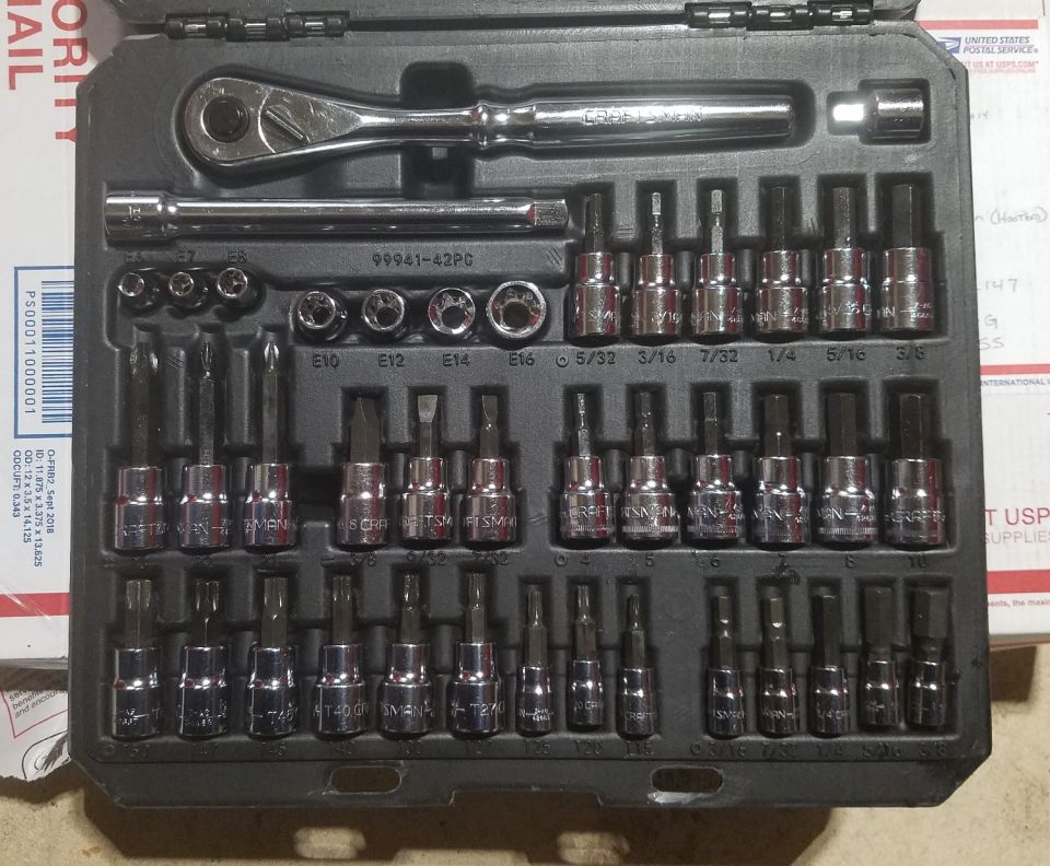 Socket wrench and assorted bits in a black case. Some bits have sizes like 5/32, 7/32, 1/4, 5/16, 3/8