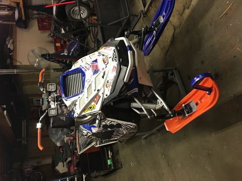 2000 Ford E350 - Snowmobile with custom graphics and lighting modifications is parked indoors.