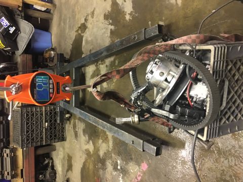 2000 Ford E350 - A transmission is suspended and weighed on a digital scale, with a prominent black belt visible.