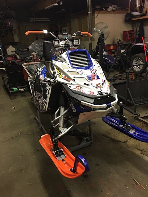 2000 Ford E350 - This snowmobile is displayed on a stand inside a garage setting.