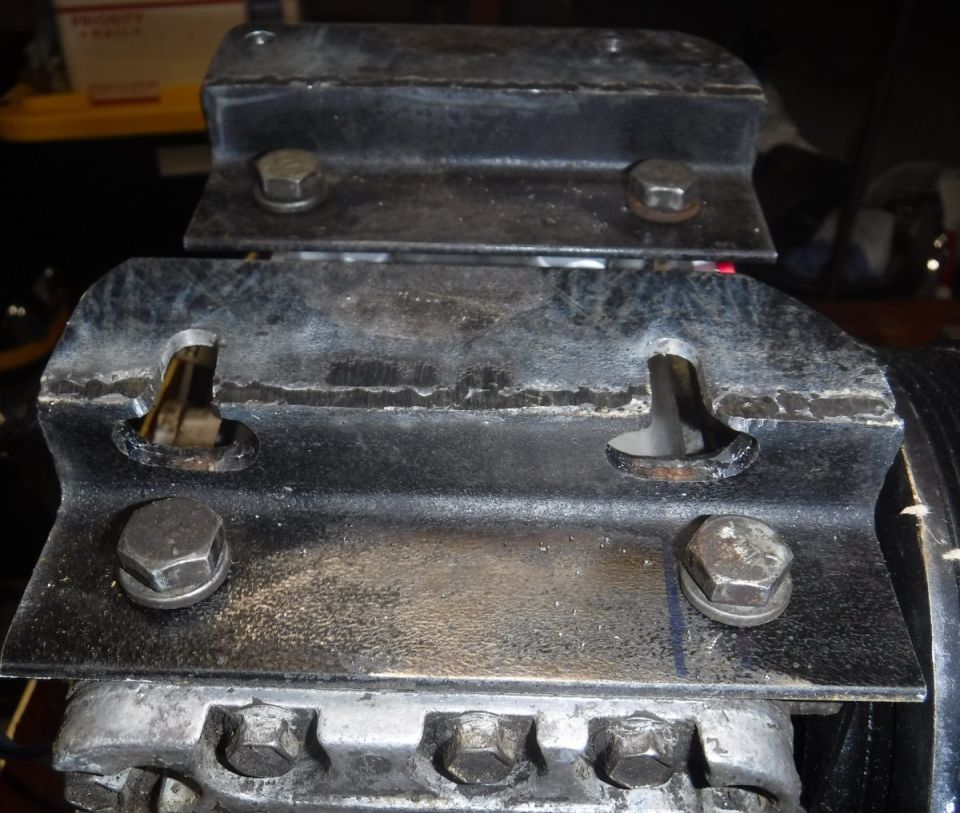 Angle iron mount; had to slot the two lower bolt holes and pre-thread them most of the way in, since there wouldn't be room to insert them otherwise.