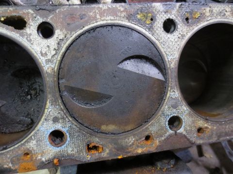 1967 Ford F-250 - This image shows a close-up view of an engine's cylinder block and a piston, exhibiting signs of wear and corrosion.