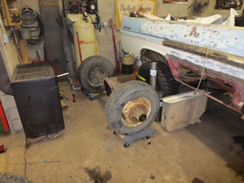 1967 Ford F-250 - Drivetrain components and a partially disassembled 1967 Ford F-250 truck bed in a garage setting.
