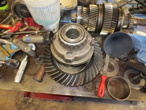 1967 Ford F-250 - Close-up of disassembled differential components and various mechanic's tools laid out on a metal surface.