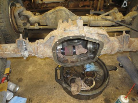1967 Ford F-250 - The rear differential is disassembled, with parts laid out in a drain pan for service.