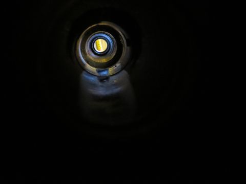 1967 Ford F-250 - Looking through the opening of an exhaust pipe.