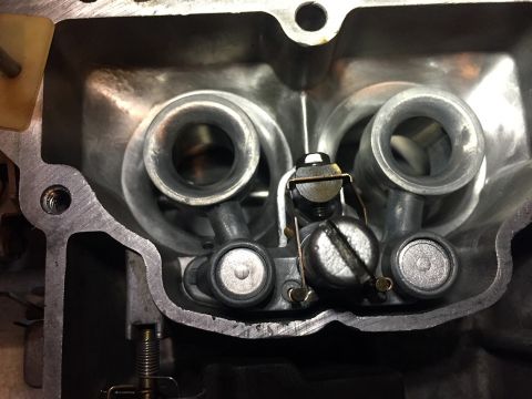 1978 Ford Bronco - Close-up view of a carburetor's internal components, including intake ports and adjustment screws.