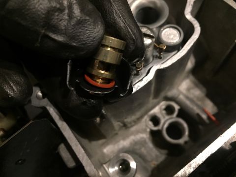1978 Ford Bronco - Installing a brass jet into a carburetor assembly.