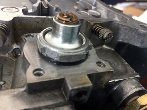 1978 Ford Bronco - Detail of a carburetor component, likely an idle mixture screw and diaphragm housing, with visible SuperMotors branding.