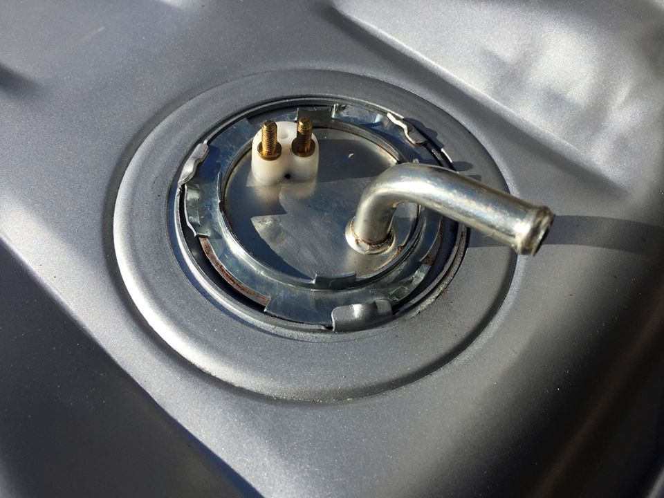 Fuel tank sending unit with metal fuel line and electrical connectors