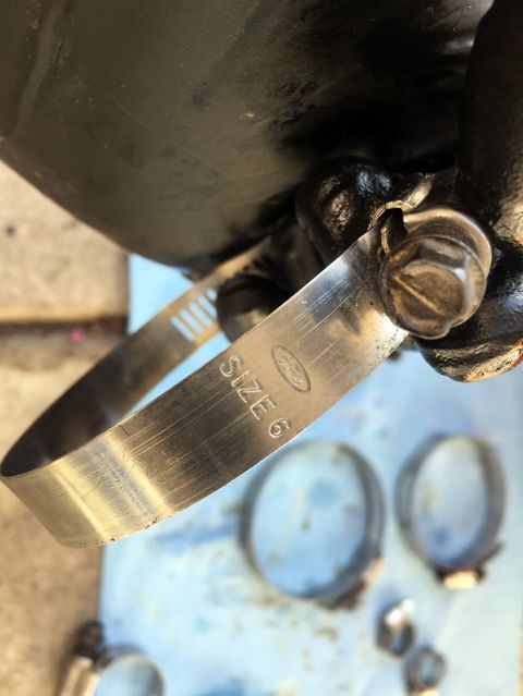 1978 Ford Bronco - A metal hose clamp, marked 'SIZE 6' and a Ford logo, is shown with other clamps.