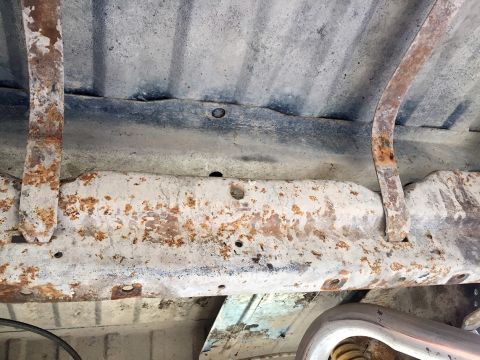 1978 Ford Bronco - Close-up of a rusty vehicle undercarriage, showing frame rails and suspension parts.