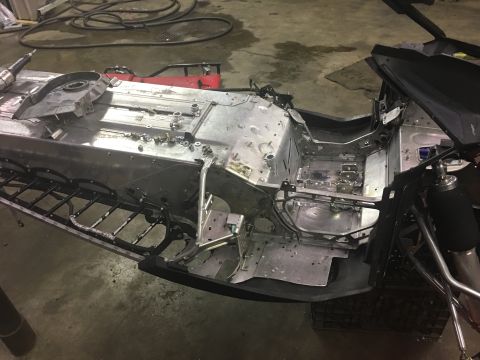 2000 Ford E350 - Disassembled snowmobile chassis in a workshop, showing the frame and internal components.