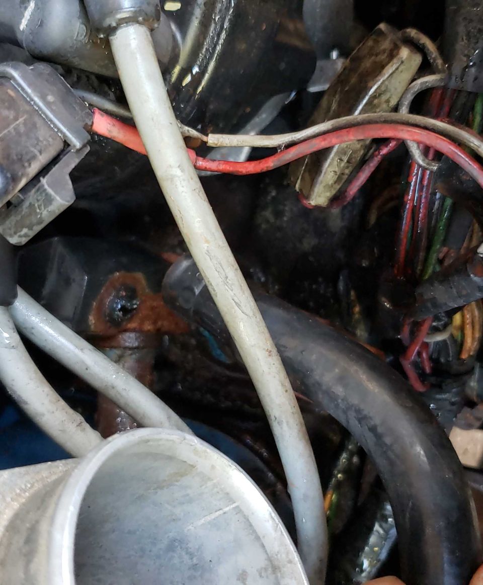 Close-up of engine bay with various wires and hoses visible