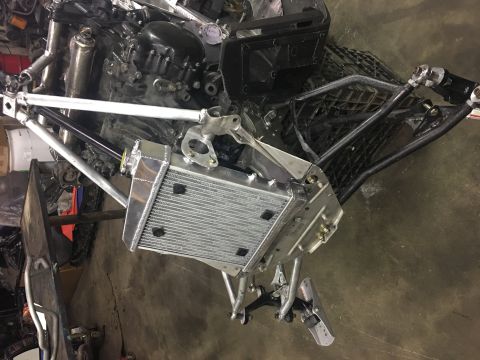 2000 Ford E350 - Close-up of snowmobile components including engine, radiator, and front suspension assembly.