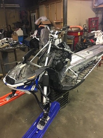2000 Ford E350 - Snowmobile chassis and engine assembly in a workshop setting.