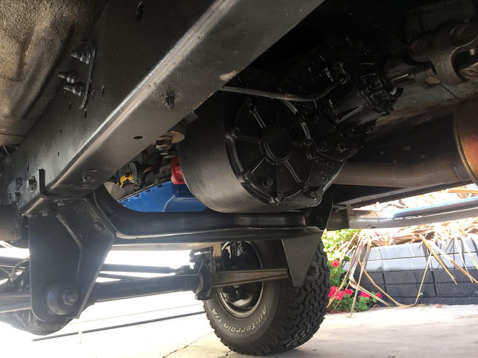 Undercarriage view of a vehicle's transfer case and exhaust pipe