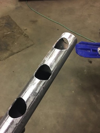 2000 Ford E350 - Metal tube with cutouts, possibly a custom part or component.