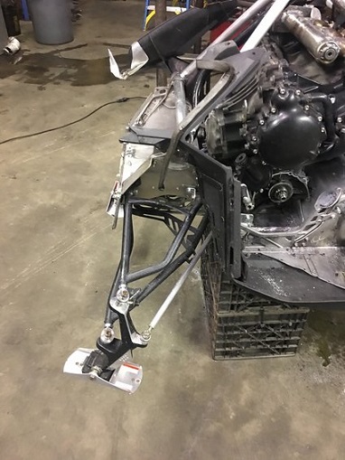 2000 Ford E350 - Close-up of a snowmobile's front suspension and engine assembly, showing mechanical components.
