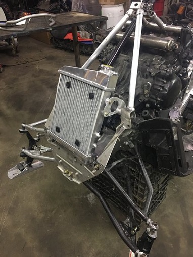 2000 Ford E350 - A close-up view of a radiator and engine assembly, likely part of a custom build or repair project.
