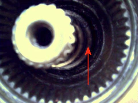 1986 Ford Bronco - A close-up view of a gear mechanism, with a red arrow highlighting internal splines.