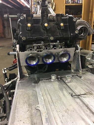 2000 Ford E350 - Custom engine intake manifold assembly with a turbocharger and adapter plate, likely for a performance application.