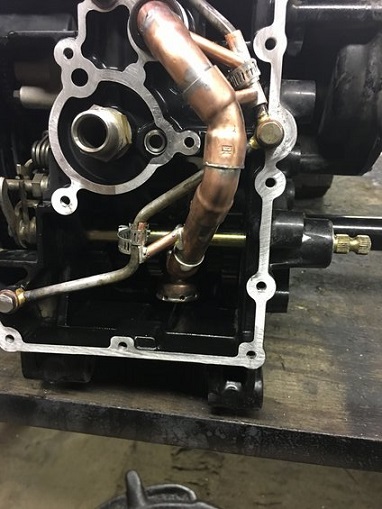 2000 Ford E350 - Close-up of an engine component with visible copper pipes and metal housing.