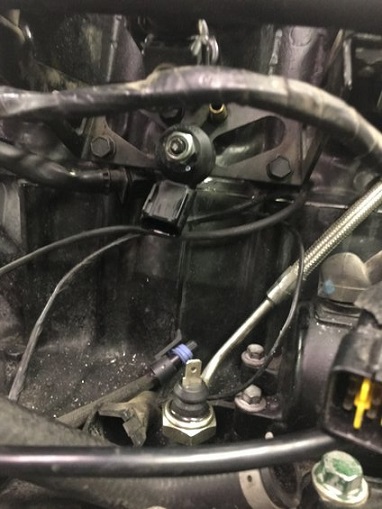 2000 Ford E350 - Engine bay detail showing various sensors and electrical connections. SuperMotors.net logo is present.