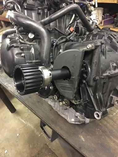 2000 Ford E350 - A close-up view of a black ribbed pulley attached to an engine component.