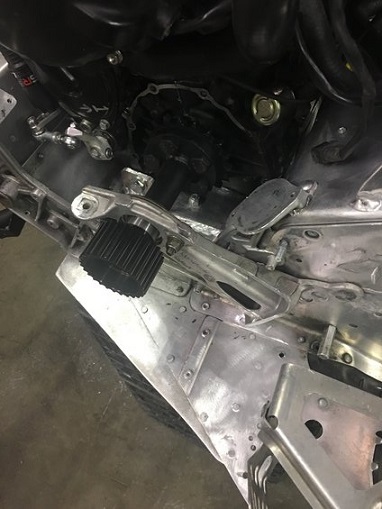 2000 Ford E350 - Detail of snowmobile mechanical components, including an air filter and drivetrain linkages.