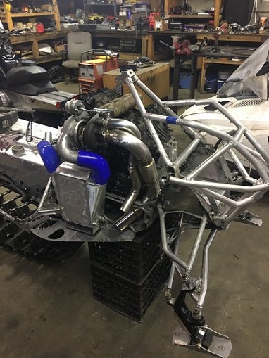 2000 Ford E350 - Custom snowmobile chassis undergoing modification with a prominent turbocharger and intercooler system installed.