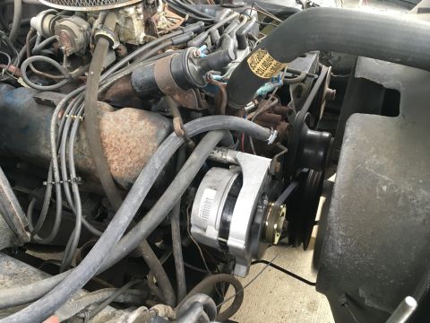 1979 Ford F-150 - The engine bay of a vehicle is shown, with various mechanical components visible.