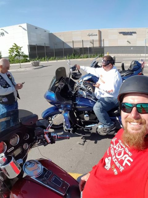 2014 Harley-Davidson FXDWGI Wide Glide - Three men pose with their motorcycles in a parking lot outside a shopping center.
