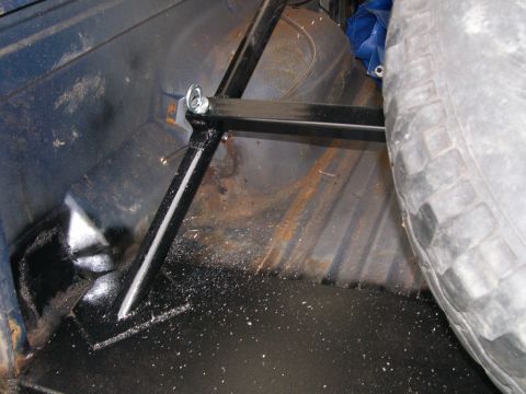 1986 Ford Bronco - Custom spare tire mount installed in the rear cargo area of a vehicle.