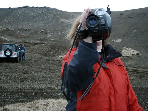 1996 Ford Bronco - A person films a Jeep Wrangler in a barren, rocky landscape.