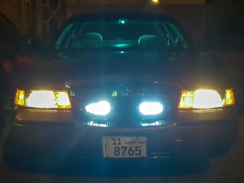 2001 Mercury Grand Marquis - The front of a 2001 Mercury Grand Marquis is illuminated by its headlights, displaying a license plate from Kuwait.