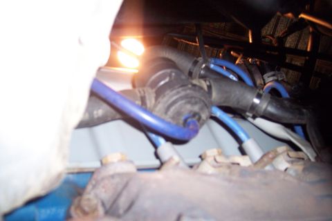 1995 Ford Bronco - Close-up view of engine components, including hoses and a valve, with visible text from Supermotors.net.