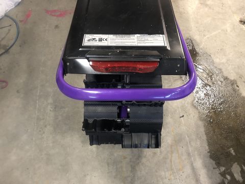 2019 Arctic Cat Mountain Cat 800 - Rear view of a snowmobile showing its track system and taillight assembly.