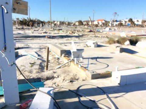 1992 Ford Bronco - A scene of widespread destruction with debris scattered across the land, indicating a significant disaster event.