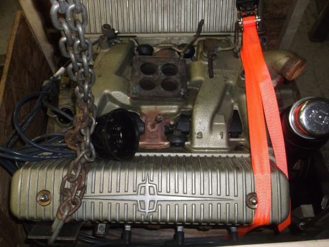 1956 Lincoln Continental - This engine is secured with chains and straps, suggesting it's being moved or stored.