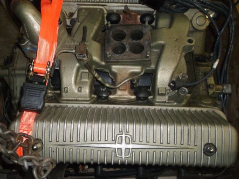 1956 Lincoln Continental - Close-up of an engine part, possibly a valve cover, with a Lincoln emblem visible.