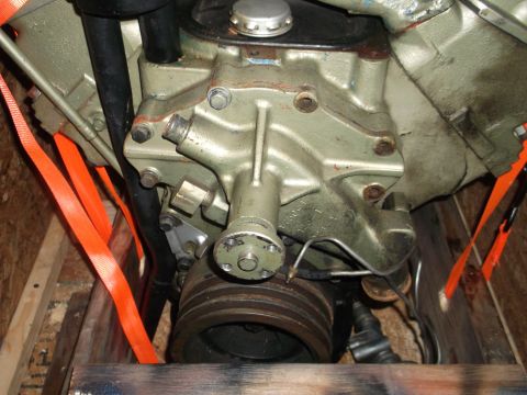 1956 Lincoln Continental - Close-up view of an engine part, secured with orange straps within a wooden crate.
