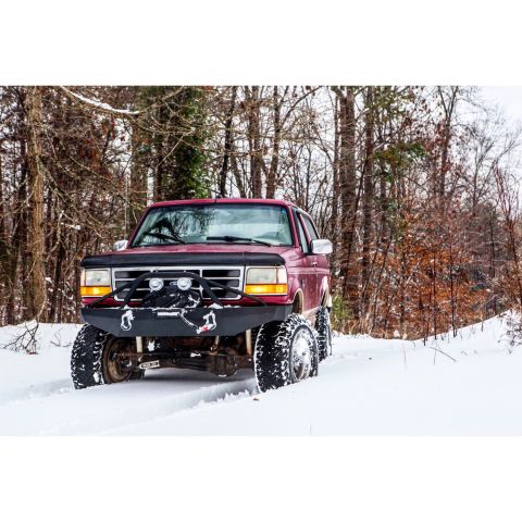1995 Ford Bronco - This 1995 Ford Bronco is navigating a snowy forest road.