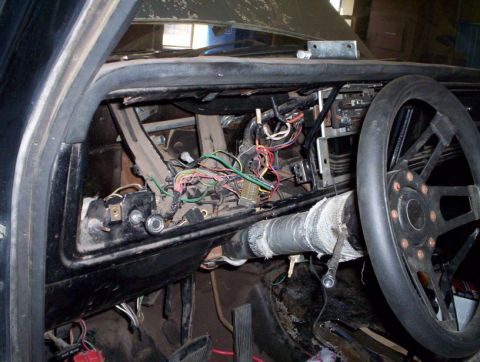 1978 Ford Bronco - Dashboard wiring is exposed, with the steering wheel visible on the right side.