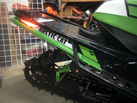 2019 Arctic Cat Mountain Cat 800 - This snowmobile features the "Arctic Cat" logo and distinctive green bodywork, seen from the rear.