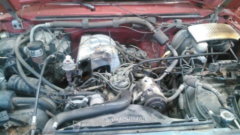 1991 Ford F-150 - Close-up view of a vehicle's engine bay, showing various mechanical parts and wiring.