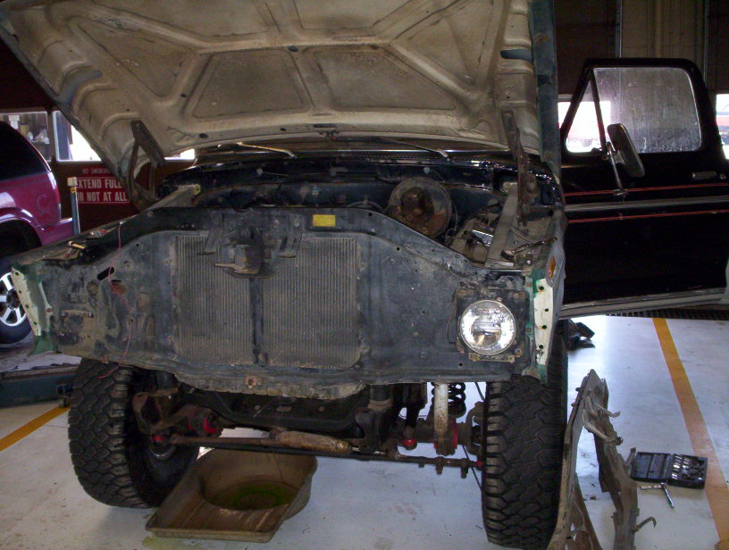 1978 Ford Bronco with hood open, front end disassembled, in a garage