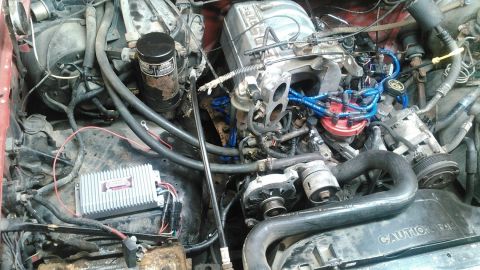 1991 Ford F-150 - Detailed view of the engine compartment in a 1991 Ford F-150, highlighting various engine components and wiring.