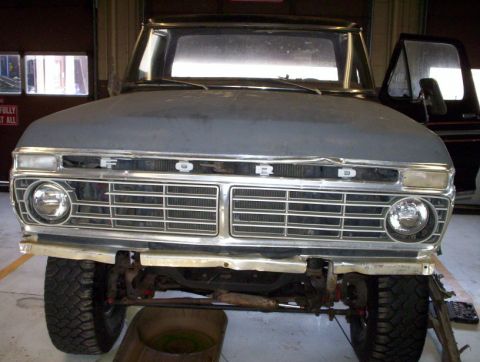 1978 Ford Bronco - Front view of a 1978 Ford Bronco undergoing restoration, showing the grille and headlights.