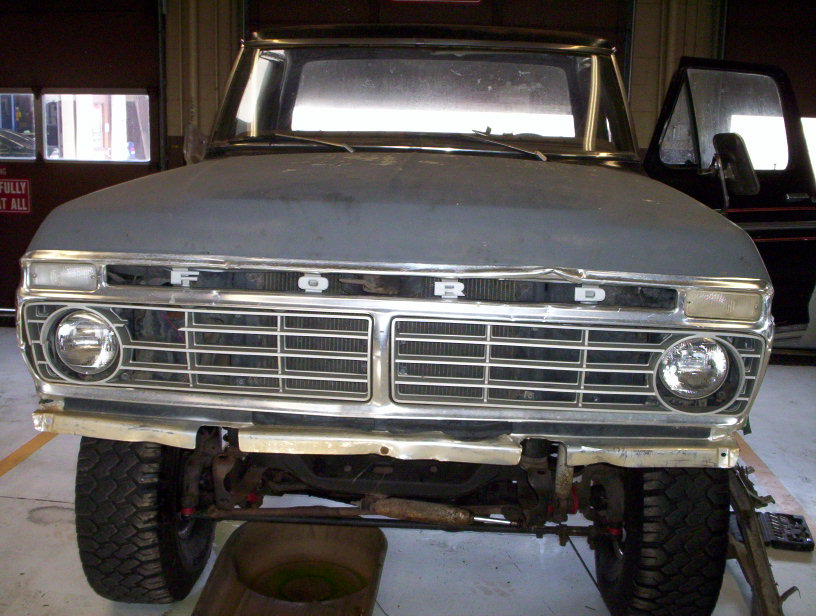 1978 Ford Bronco front end with grille and headlights visible, hood is gray primer
